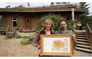Gord and Ann holding their award for the Living Building Challenge