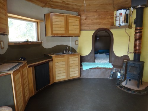 Inside the Eco-Hut with archway into sleeping nook.